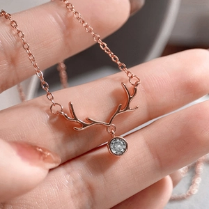 Close-up of rose gold elk antler necklace with a round sparkling zircon pendant