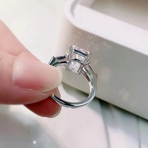 Detailed view of square cut pink zircon ring with baguette side stones on silver band