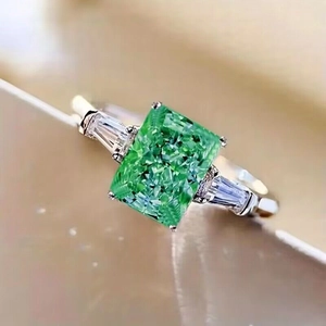 Elegant emerald cut green gemstone ring with side diamonds on silver band for women