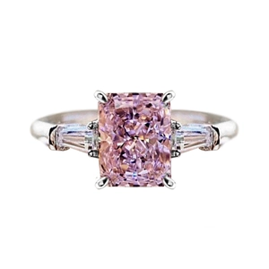 Classic three-stone ring featuring a rectangular pink zircon and white side stones
