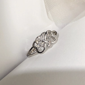 Close-up of interlocking silver double hearts ring with micro-pave white zircon stones