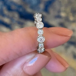 Macro view of sterling silver eternity ring featuring brilliant round-cut bezel-set zircons
