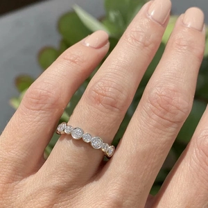 Macro shot of silver bezel-set eternity ring with sparkling round cubic zirconia