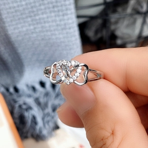 Detail shot of micro-pave heart ring in silver finish with sparkling white crystals