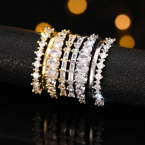 Macro shot of a seven-piece stackable ring set with multiple gemstone cuts on a black stand