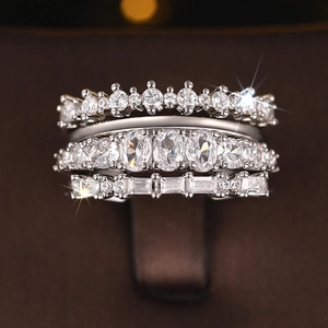 Macro shot of silver-colored tiered rings set with brilliant white cubic zirconia gems