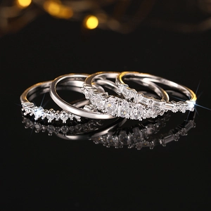 Three-piece silver ring set with zircon stones on a luxury black reflective background