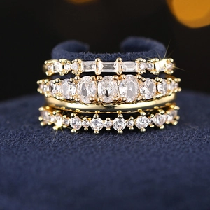 Macro shot of gold geometric stackable rings set with white cubic zirconia crystals