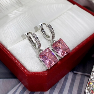 Detail of pink rectangular zircon earrings with pave small diamonds in a luxury gift box