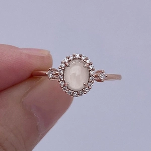 French vintage rose gold ring with oval cabochon stone and halo diamond accents