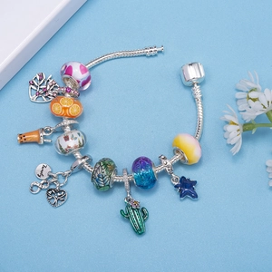 DIY charm bracelet with silver snake chain, colorful beads and family tree pendant