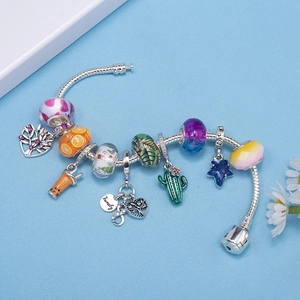 DIY charm bracelet with silver snake chain, colorful glass beads and family pendants