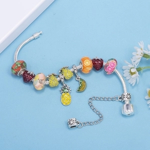 Colorful fruit charms bracelet featuring pineapple strawberry and lime on silver snake chain