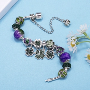 Silver four-leaf clover charm bracelet with purple beads and green leaf pendants