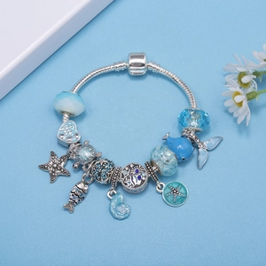 Ocean-themed charm bracelet featuring blue glass beads and marine animal pendants