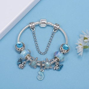 Ocean themed silver bracelet with blue glass beads, turtle charms and shell pendants