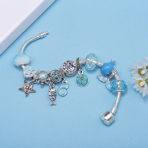 Ocean themed DIY charm bracelet with blue sea turtle and starfish pendants for women