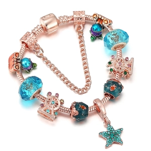 Rose gold DIY charm bracelet with light blue beads, star pendant and safety chain