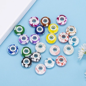 Close-up of assorted gradient glass beads with silver metal cores for DIY jewelry making