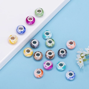 Close-up of assorted gradient resin beads with metal cores for DIY jewelry crafting