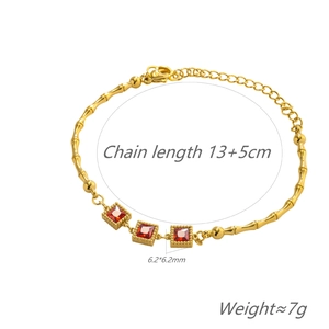 Detail view of gold bamboo chain bracelet with square red stones and size markings