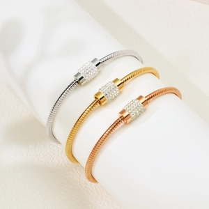 Set of three sparkling pave crystal bracelets in silver, gold, and rose gold finishes