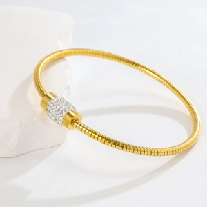 Elegant rose gold snake chain bracelet featuring a rotating cylinder pavé with sparkling crystals