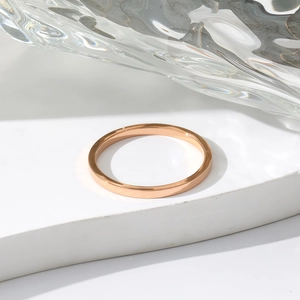 Minimalist rose gold stainless steel ring with a polished surface on white stone