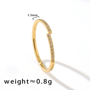 Detailed view of a 1.3mm thin titanium steel gold ring with zirconia stone inlay