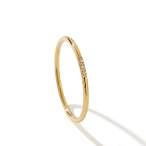 Minimalist 18k gold plated titanium steel ring with three inlaid zircons on white base