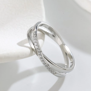Crossed titanium steel ring with sparkling pavé cubic zirconia inlay in a minimalist design