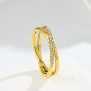 Detail of cross double ring design with gold finish and micro-inlaid white cubic zirconia