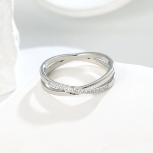 Detail of silver crossover ring with micro-pave cubic zirconia on polished steel