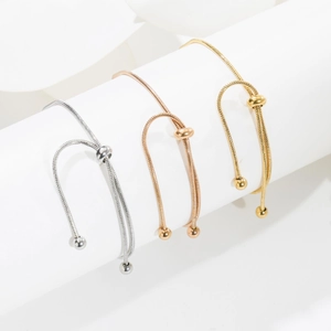 Three-color adjustable snake chain bracelets in silver, gold, and rose gold on display