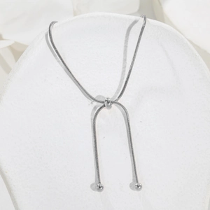 Detailed macro view of adjustable silver snake chain necklace with round sliding clasp bead