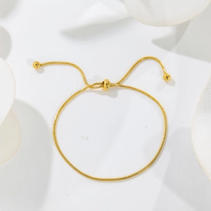 Adjustable gold snake chain bracelet with slider bead and polished gold ball ends