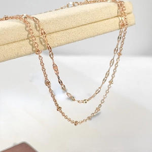 Detail view of double-layered rose gold stainless steel chain with beaded texture