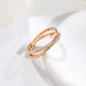 Close-up of rose gold crisscross ring with micro-pave white cubic zirconia stones