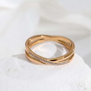 Elegant 18K rose gold crisscross ring with polished band and sparkling cubic zirconia stones