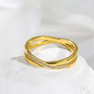 Detail shot of rose gold criss-cross ring with pavé sparkling cubic zirconia stones