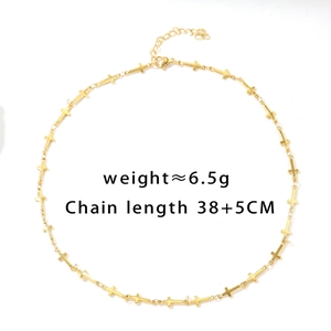 Detail of golden cross necklace with lobster clasp, 38+5cm chain length and 6.5g weight
