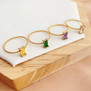 Set of four gold twisted band rings with colorful rectangular gemstone inlays