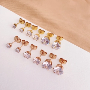 Detail of 12 sparkling zircon studs in gold and rose gold with butterfly backings