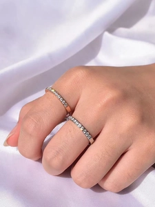 Close-up of elegant rose gold and silver thin rings with sparkling pave zircon settings