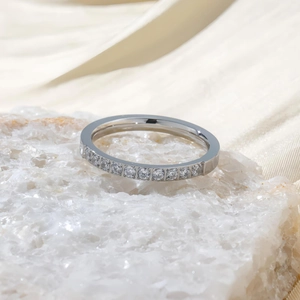 Détail d'une bague en acier titane sertie de zircons brillants sur cristal blanc