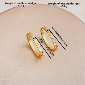 Primer plano de anillos de acero de titanio dorado con grabados de flores de estrella