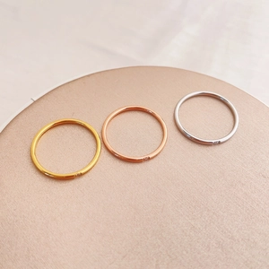 Three-piece set of minimalist slim band rings in gold, rose gold, and silver finishes
