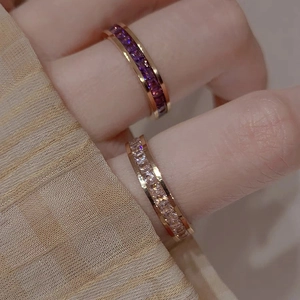 Elegant rose gold pave set crystal rings featuring purple and white stones on hand