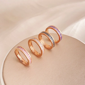 Set of four stackable rose gold rings with square-cut rhinestones in assorted colors