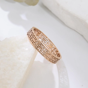 Polished rose gold hollow ring with classic geometric Greek key pattern on stone